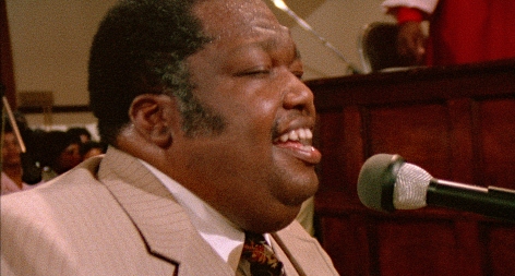Gospel giant singer and pianist Edgar O’Neal (the O’Neal Twins), in SAY AMEN, SOMEBODY, the 1982 classic Gospel documentary directed by George Nierenberg. Film to 4K digital restoration by Metropolis Post, New York: Jack Rizzo, Ian Bostick (restoration artist), Jason Crump (colorist) and Allen Perkins. Audio Restoration and 5.1 Sound by Audio Mechanics. Sound Engineer: John Polito. Restoration Produced by Milestone Film & Video, the Smithsonian National Museum of African American History and Culture and the Academy Film Archive. Funding by Robert F. Smith Fund Professional Curation Project and the Academy Film Archive. Supervised by George Nierenberg and Dennis Doros.